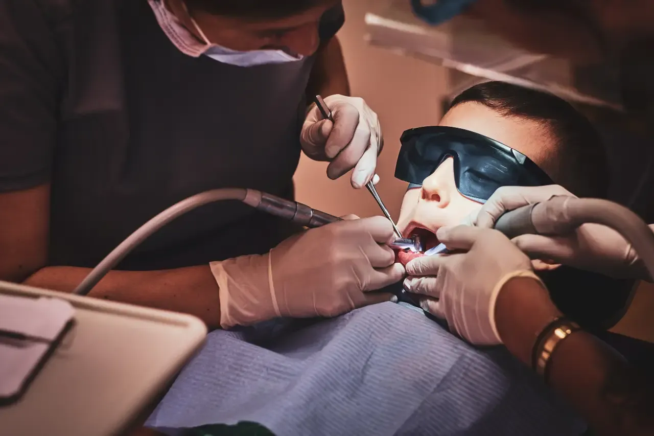 brave-small-child-gets-dental-treatment-by-expirienced-doctor-dental-clinic